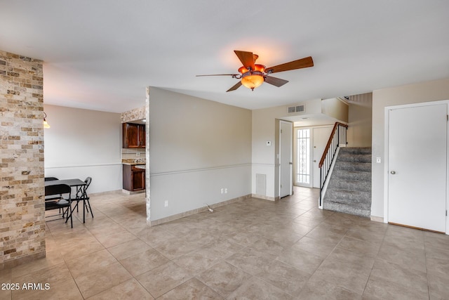 8225 N Central Ave Unit 44, Phoenix, AZ 85020 - unfurnished living room featuring stairs, ceiling fan, visible vents, and light tile patterned floors