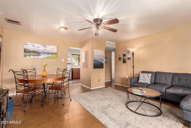 3031 E Avalon Dr, Phoenix, AZ 85016 - living area with ceiling fan, baseboards, and finished concrete floors