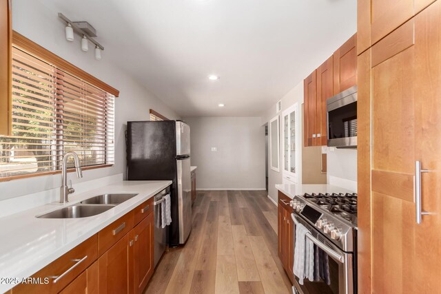 3031 E Avalon Dr, Phoenix, AZ 85016 - kitchen featuring stainless steel appliances, a sink, brown cabinets, healthy amount of natural light, and recessed lighting