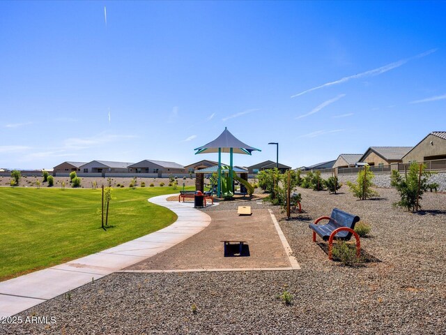 community playground with a yard and fence