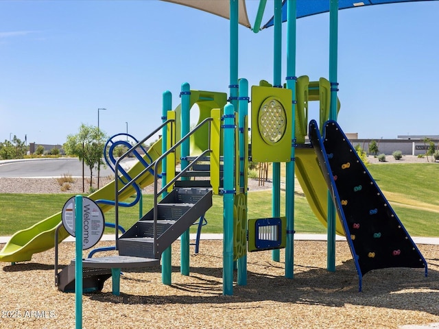 community jungle gym featuring a yard