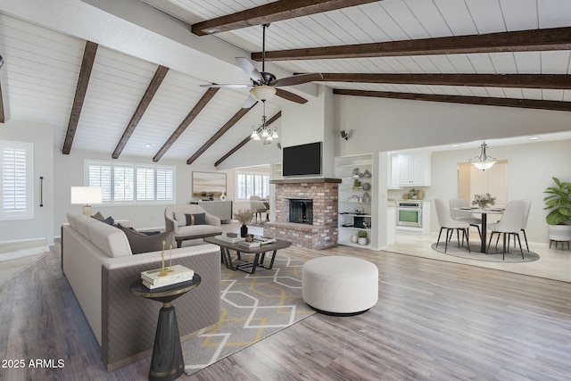 2178 E Golf Ave, Tempe, AZ 85282 - living room featuring wooden ceiling with exposed beams, wood finished floors, ceiling fan, a brick fireplace, and high vaulted ceiling