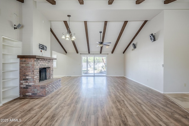 2178 E Golf Ave, Tempe, AZ 85282 - unfurnished living room featuring ceiling fan, wood finished floors, a fireplace, baseboards, and wooden ceiling with exposed beams