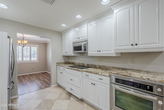 2178 E Golf Ave, Tempe, AZ 85282 - kitchen featuring appliances with stainless steel finishes, baseboards, white cabinetry, a chandelier, and light tile patterned flooring