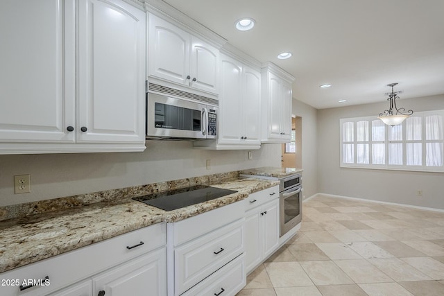 2178 E Golf Ave, Tempe, AZ 85282 - kitchen with stainless steel appliances, baseboards, white cabinets, light stone counters, and decorative light fixtures