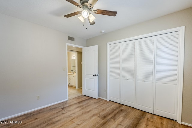 2178 E Golf Ave, Tempe, AZ 85282 - unfurnished bedroom featuring light wood-style floors, a sink, baseboards, a closet, and a ceiling fan
