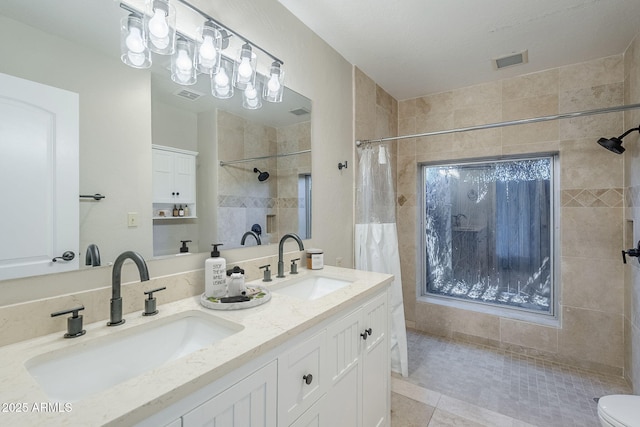 2178 E Golf Ave, Tempe, AZ 85282 - full bathroom with a tile shower, double vanity, toilet, and tile patterned floors