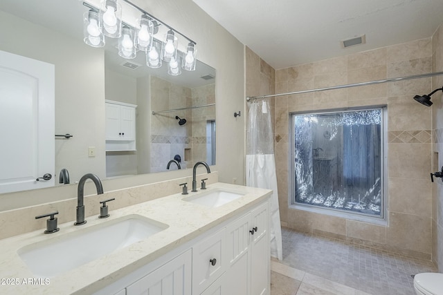 2178 E Golf Ave, Tempe, AZ 85282 - full bath featuring a tile shower, double vanity, toilet, and tile patterned floors