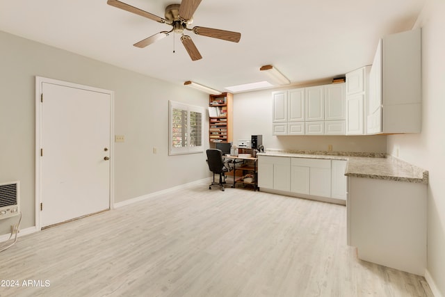 office space with ceiling fan, heating unit, and light hardwood / wood-style floors