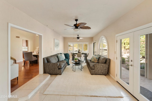 living room with a healthy amount of sunlight, ceiling fan, light hardwood / wood-style flooring, and french doors