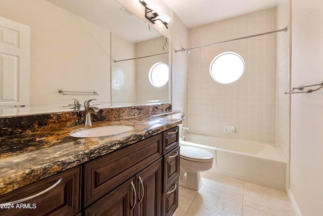 full bathroom featuring vanity, tiled shower / bath combo, toilet, and tile patterned flooring