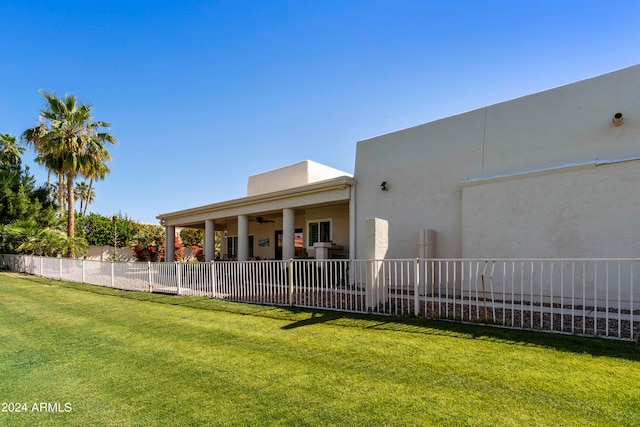 rear view of property featuring a yard