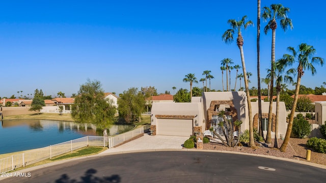 view of front of house with a water view and a garage