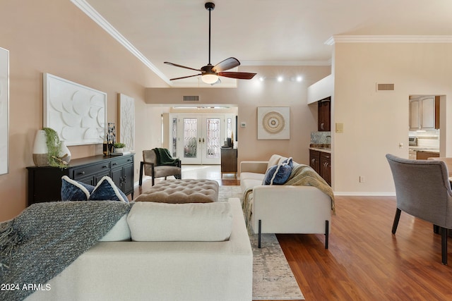 living room with ornamental molding, ceiling fan, french doors, and hardwood / wood-style flooring