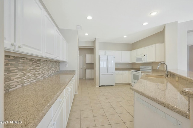 kitchen with white cabinetry, light stone counters, white appliances, and sink