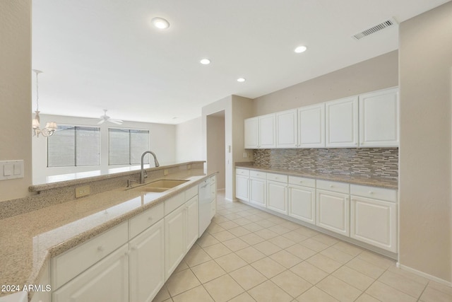 kitchen with white cabinetry, sink, light stone countertops, decorative backsplash, and light tile patterned floors