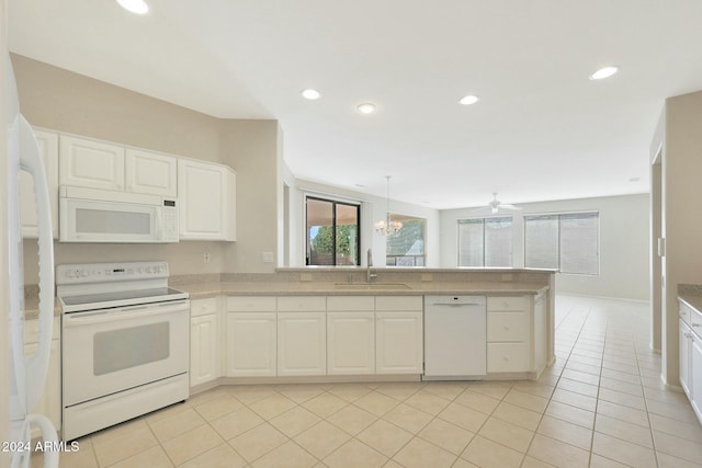 kitchen featuring white cabinetry, sink, white appliances, light tile patterned floors, and ceiling fan with notable chandelier