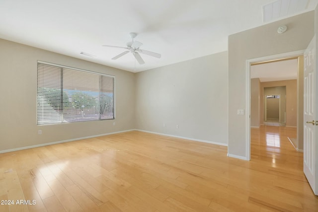 spare room featuring ceiling fan and light hardwood / wood-style floors