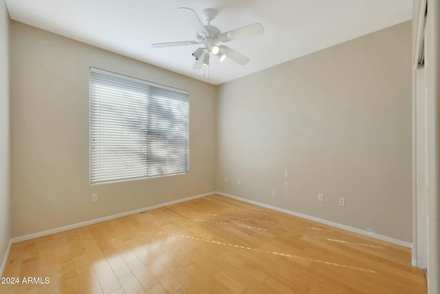 spare room featuring ceiling fan and light wood-type flooring