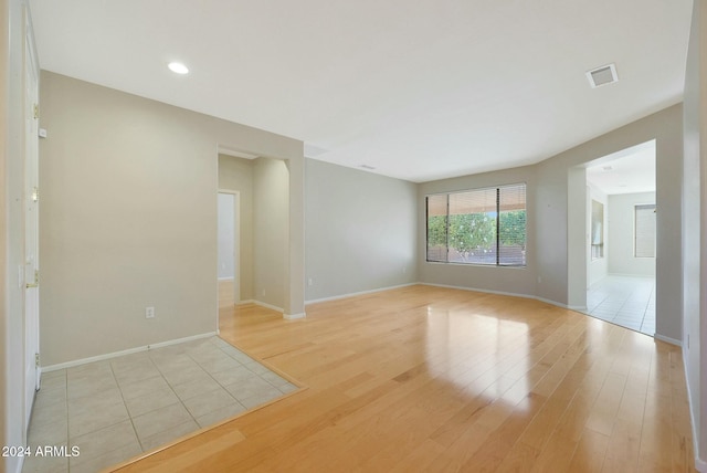 unfurnished room with light wood-type flooring