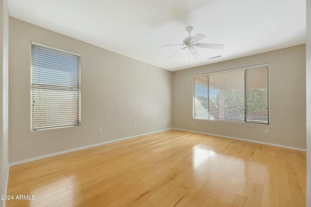 empty room featuring ceiling fan and light wood-type flooring