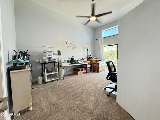 carpeted office space featuring ceiling fan