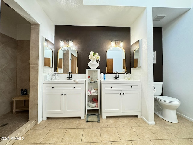 bathroom with tile patterned floors, vanity, and toilet