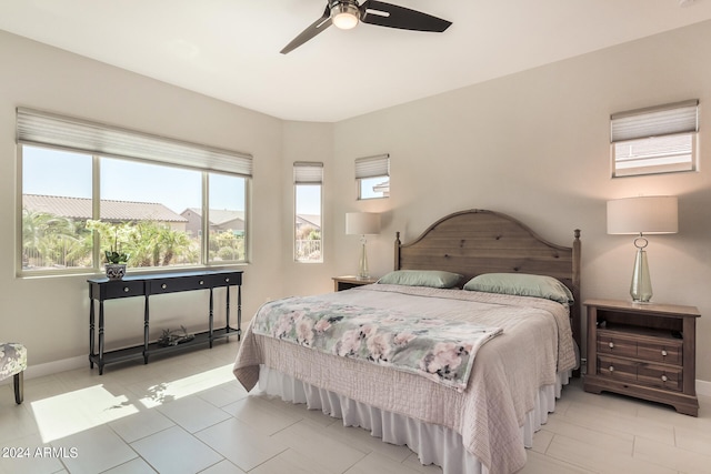 tiled bedroom featuring ceiling fan