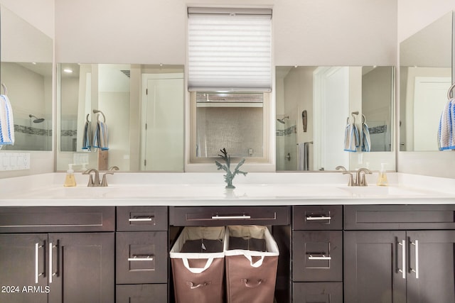 bathroom with a shower with shower door and vanity