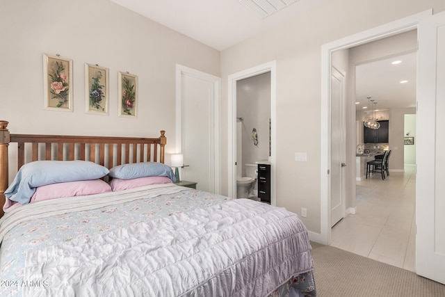 tiled bedroom featuring ensuite bathroom