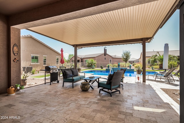 view of patio / terrace with a fenced in pool and a grill