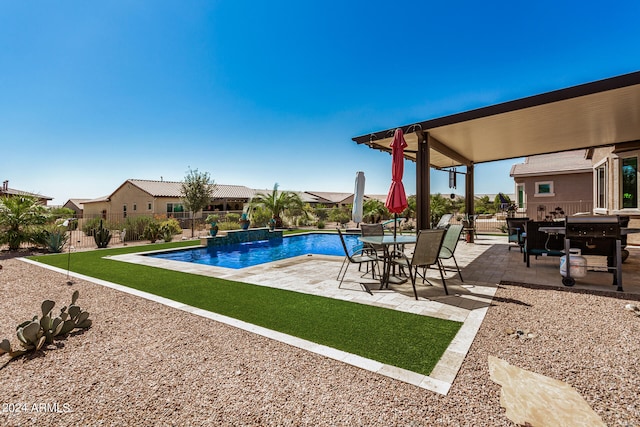 view of pool featuring a yard, a patio, and pool water feature