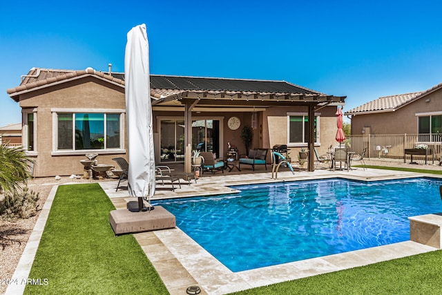 back of property with a patio and a fenced in pool