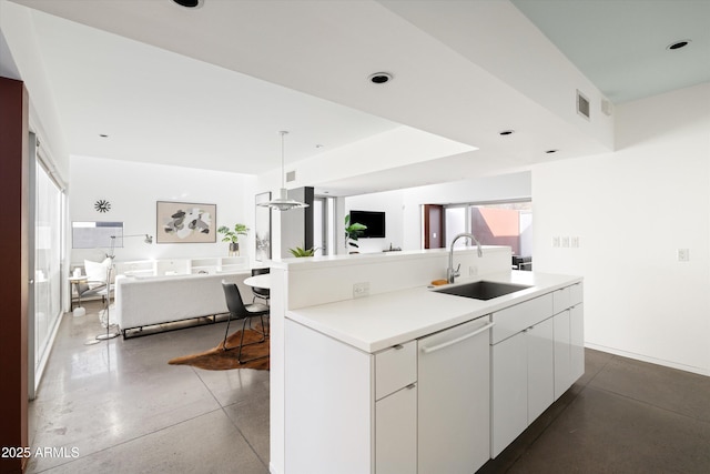 kitchen with a sink, visible vents, open floor plan, white dishwasher, and a kitchen island with sink