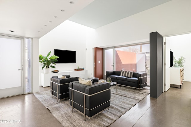 living area featuring concrete floors