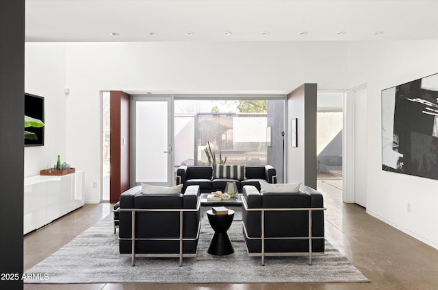 living area featuring recessed lighting and concrete floors