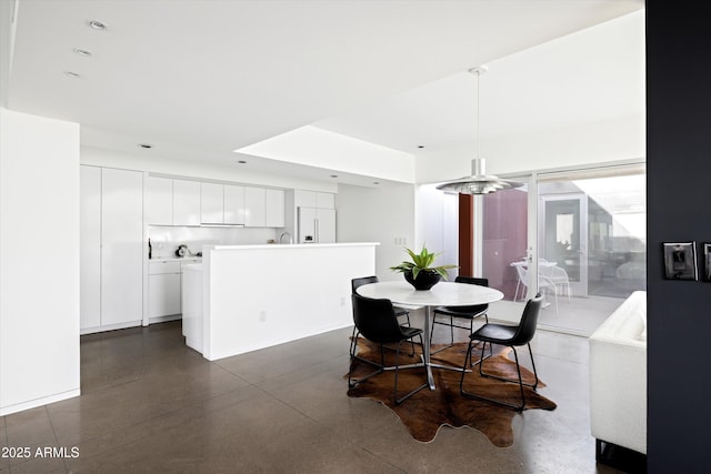 dining space featuring finished concrete floors