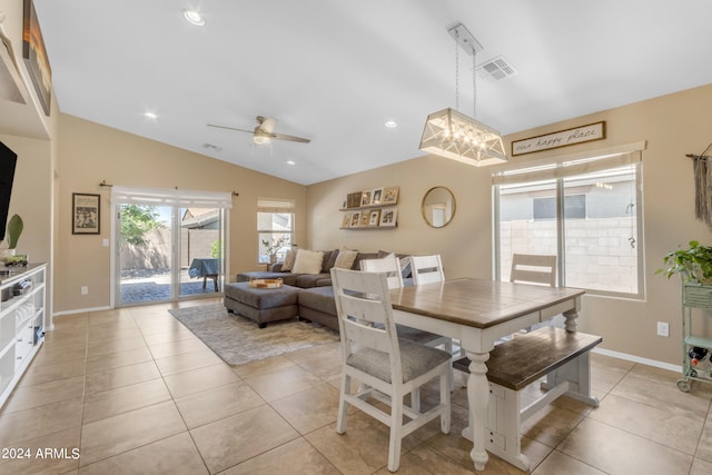 tiled dining area featuring vaulted ceiling and ceiling fan