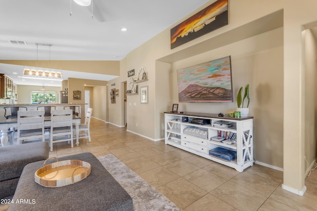 living room featuring lofted ceiling and light tile patterned floors