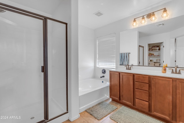 bathroom featuring vanity, shower with separate bathtub, and tile patterned flooring