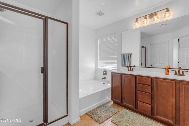 bathroom with tile patterned flooring, vanity, and shower with separate bathtub