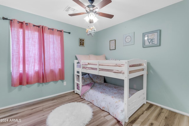 bedroom with wood-type flooring and ceiling fan