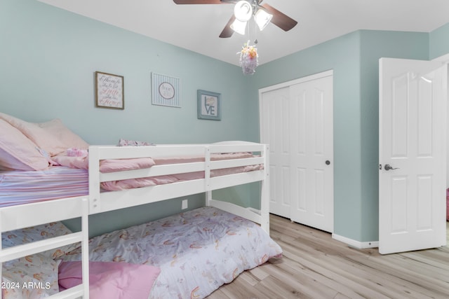 bedroom with light hardwood / wood-style flooring, a closet, and ceiling fan