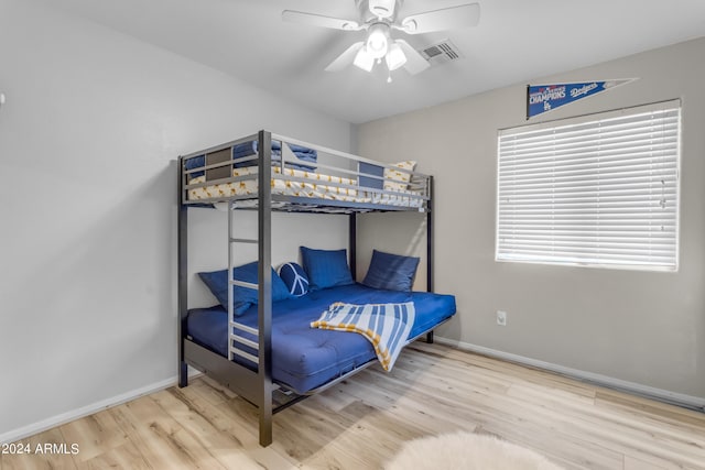 bedroom with hardwood / wood-style floors and ceiling fan