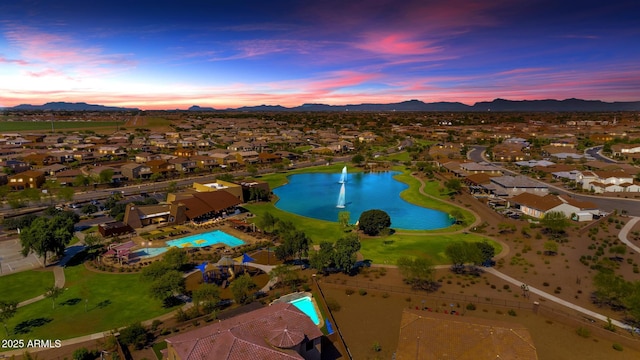 aerial view at dusk with a water and mountain view