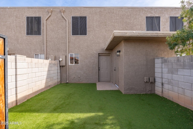 back of house with a lawn