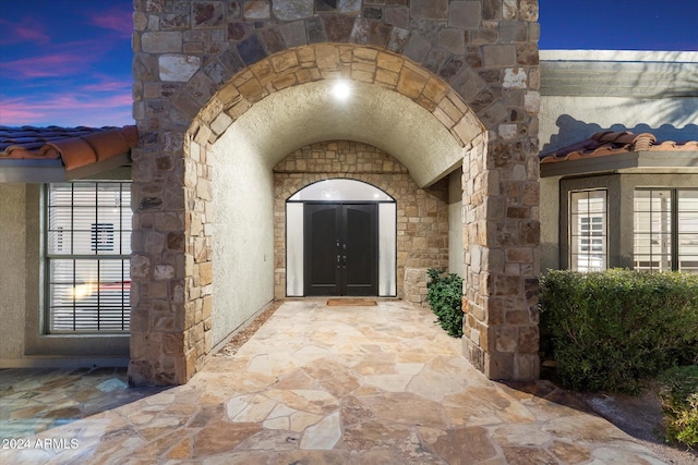 24218 N 85th St, Scottsdale, AZ 85255 - exterior entry at dusk with stone siding