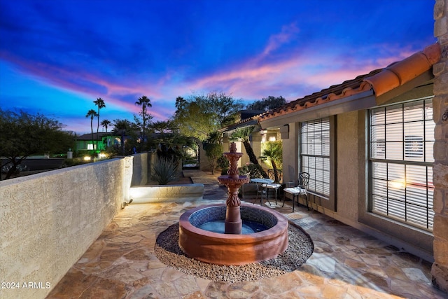 view of patio terrace at dusk