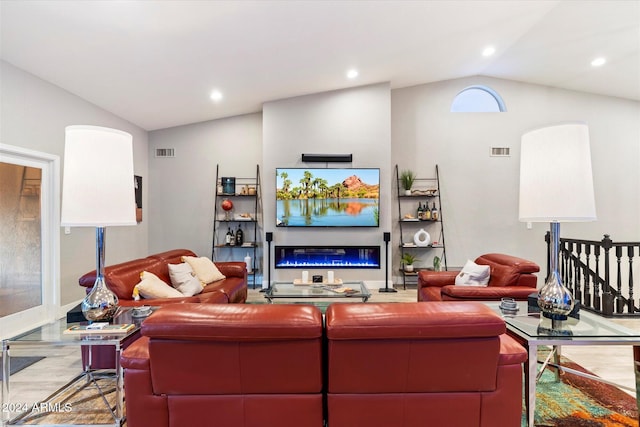 24218 N 85th St, Scottsdale, AZ 85255 - living area featuring lofted ceiling, a glass covered fireplace, wood finished floors, and recessed lighting