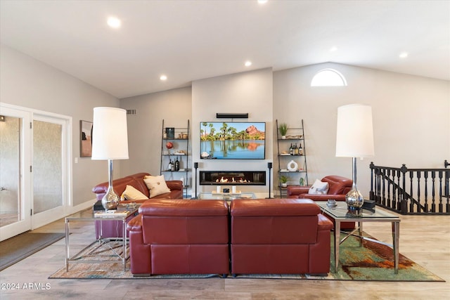 living room featuring light hardwood / wood-style flooring and lofted ceiling